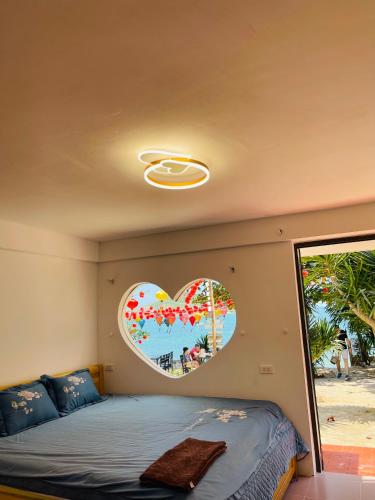 a bedroom with a heart shaped mirror on the wall at Bãi Xếp Beach in Quy Nhon