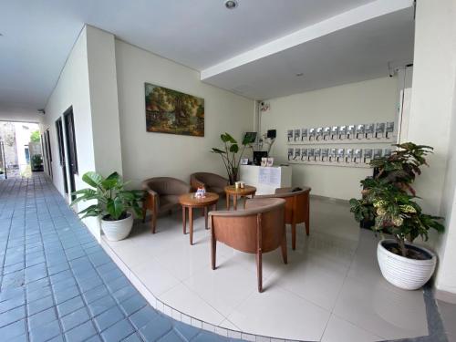 a restaurant with tables and chairs and plants at TRAM - The Seturan Raya Eksklusif Rooms in Seturan