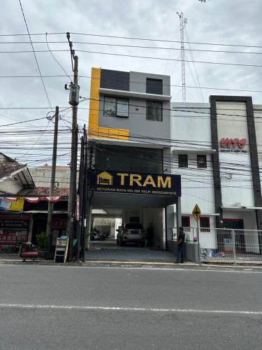 a man is standing in front of a building at TRAM - The Seturan Raya Eksklusif Rooms in Seturan