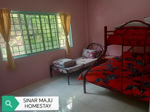 a bedroom with a bunk bed and a window at Sinar Maju Homestay in Tanah Rata