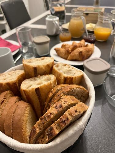 a plate of bread and pastries on a table at La Tranquillité in LʼHerbaudière