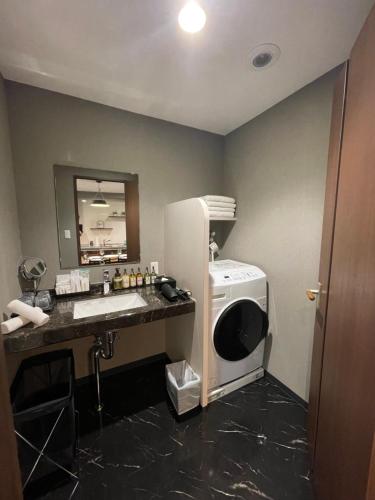 a bathroom with a sink and a washing machine at ENT TERRACE Asakusa in Tokyo