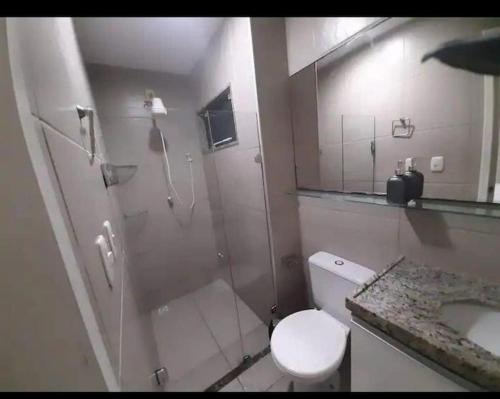 a bathroom with a shower and a toilet and a sink at Apart Canoa Quebrada vista mar- condominio fechado in Aracati