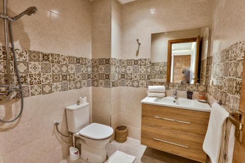 a bathroom with a toilet and a sink and a shower at Hanah Apartments by Living Essaouira in Essaouira