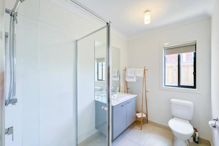 a bathroom with a shower and a toilet and a sink at Modern Clyde House Smart TV*Dryer in Clyde