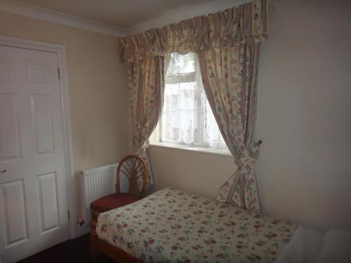 a small bedroom with a bed and a window at Gibtel Lodge & Cafe in Slough