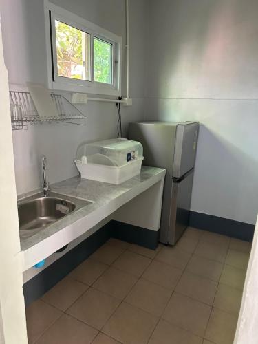 a small kitchen with a sink and a refrigerator at Haad Salad Villa in Salad Beach
