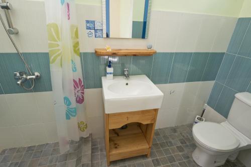 a bathroom with a sink and a toilet at Le Refuge in Rodrigues Island