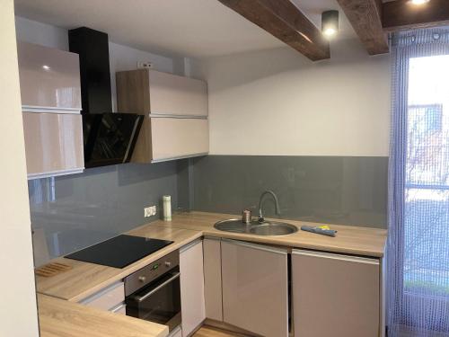 a kitchen with a sink and a counter top at A4 Luxury Apartment in Wrocław