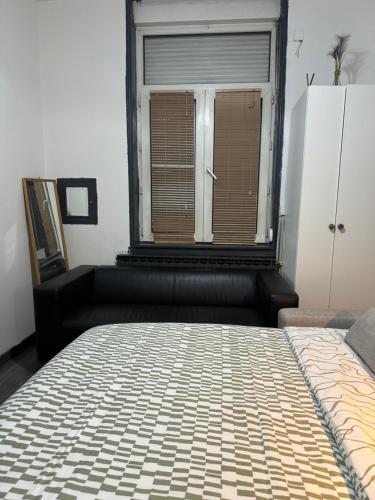 a bedroom with a bed in front of a window at Logement de Ville 4 chambres proche de Lille in Tourcoing