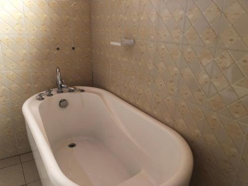 ein Bad mit einer Badewanne in einem Zimmer in der Unterkunft Luxury Furnished and Serviced Home in Kigali