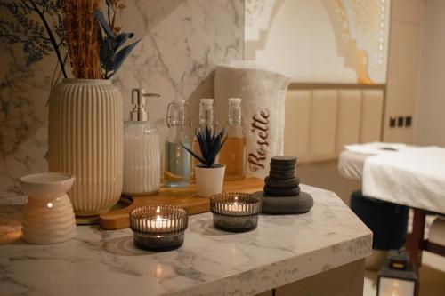 a table with vases and other items on it at Central Inn Souq Waqif in Doha