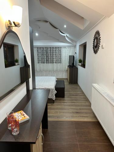 a hallway of a room with a bed and a mirror at Къща за гости Арнаудови in Kostandovo