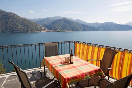 a table and chairs on a balcony with a view of a lake at Casa Bubu in Carmine