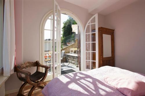 a bedroom with a bed and an open door to a balcony at Casa Bubu in Carmine