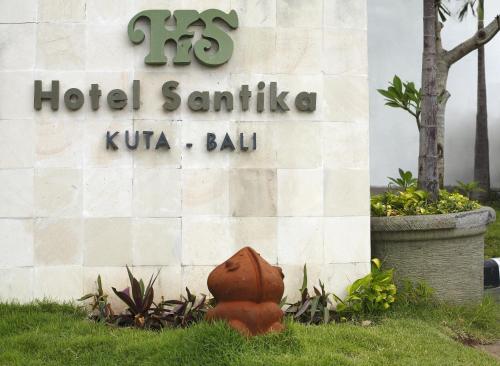a red fire hydrant in front of a hotel santinia kuna bat at Hotel Santika Kuta in Kuta