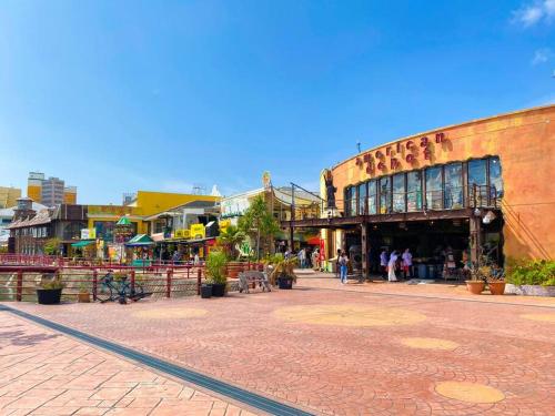 a group of people walking around a street with a building at 海まで3分！アメリカンビレッジまで5分 最大8名 Moana in Chatan