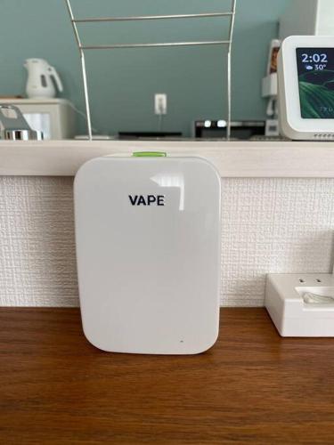 a white router sitting on top of a counter at 海まで3分！アメリカンビレッジまで5分 最大8名 Moana in Chatan