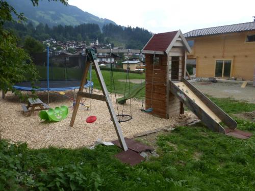 a playground with a slide and a play structure at Ferienwohnung Zillertal - Schwemberger in Fügen