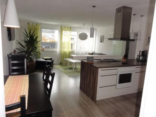 a kitchen and living room with a table and a counter at Ferienwohnung am Wildpark HDH in Heidenheim