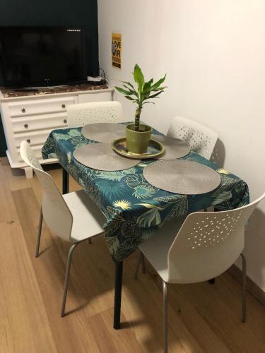 a table with chairs and a plant on top of it at Les Studios Parfaitement Imparfaits - Lens Louvre-Bollaert in Lens