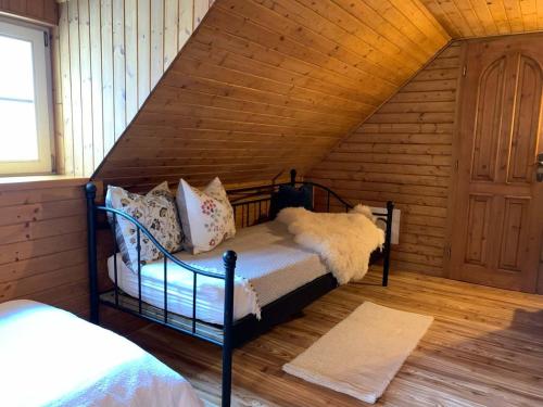 a bedroom with two bunk beds in a attic at chalupa Komora in Lužná