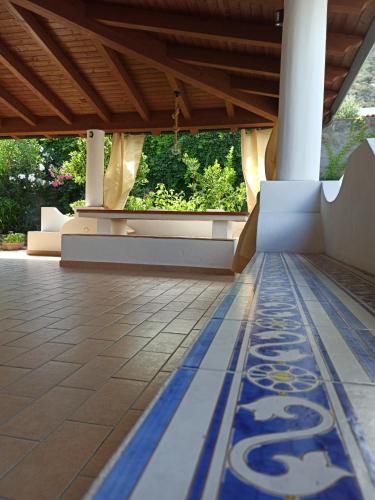 a lobby with a blue and white tile floor at Casa Volcanalia in Vulcano