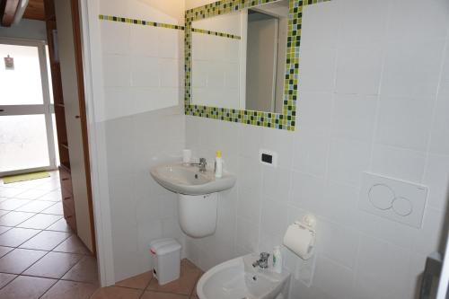 a bathroom with a sink and a toilet and a mirror at Bergamum F.L. in Bergamo