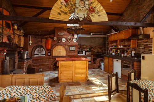 a large kitchen with wooden walls and a ceiling at La Popica in Tîrnăveni