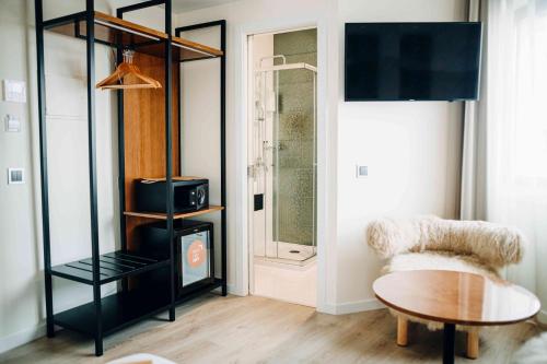 a living room with a table and a chair at Next Level Premium Hotels in Lisbon