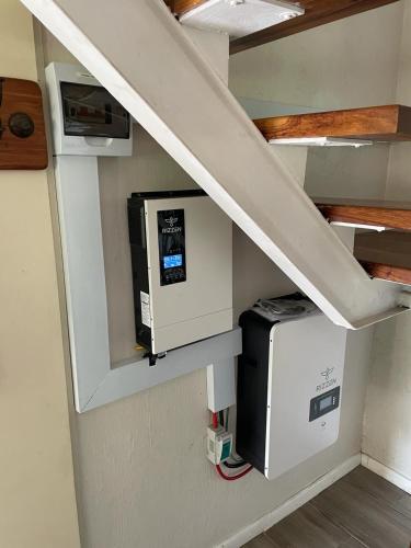a staircase with a microwave and a computer under a stair case at 20 Mount Champagne in Champagne Valley