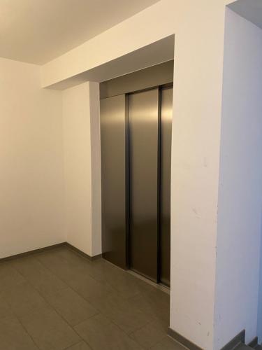 an empty hallway with elevator doors in a building at Fabella Flats Forchheim in Forchheim