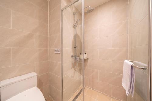 a bathroom with a shower and a toilet at Chestertons Naksan in Yangyang