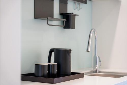 a coffee pot sitting on a counter next to a sink at Chestertons Naksan in Yangyang