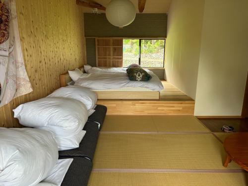 a room with four beds with a dog laying on them at Whole house rental inn Umu - Vacation STAY 60715v in Maibara