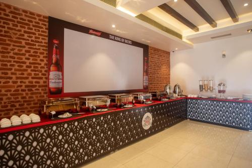 a bar with a large screen in a restaurant at Manigram Bishram Batika Pvt Ltd in Bhairahawa