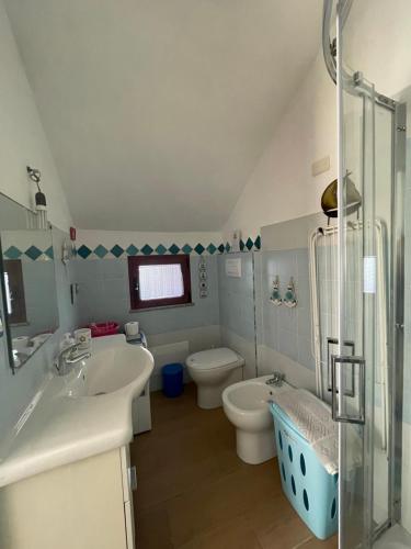 a bathroom with a sink and a toilet and a shower at Sa dommo de Mammai in Cala Gonone