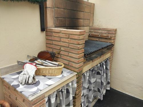 a brick oven with a basket on a table at Málaga casa grande familiar in Málaga