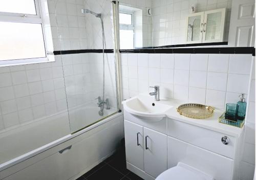 a white bathroom with a sink and a shower at Walderslade Serviced Accommodation Medway Maidstone in Kent