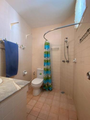 a bathroom with a toilet and a shower with a shower curtain at Casa Espana in Pattaya South
