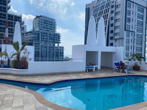 a large swimming pool with buildings in the background at Casa Espana in Pattaya South