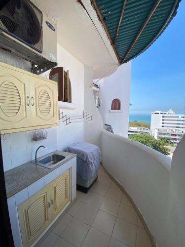 a kitchen with a sink and a view of the ocean at Casa Espana in Pattaya South