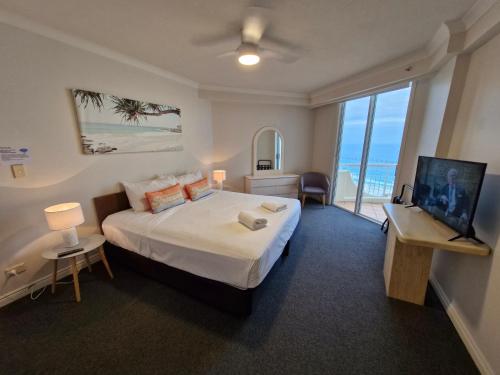 a bedroom with a large bed with a view of the ocean at APR Private SUITES MOROCCAN by the Beach in Gold Coast