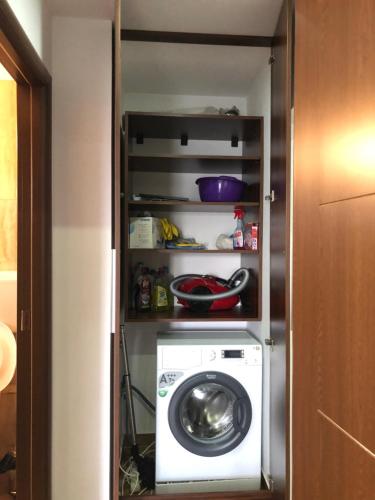 a washer and dryer inside of a room at Garsoniera Relax Drumul Taberei in Bucharest