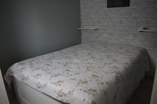 un letto in una camera da letto con muro di mattoni di Blutsyde estepona 008 bredene a Bredene