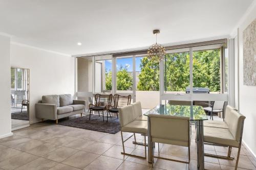 - une salle à manger et un salon avec une table et des chaises dans l'établissement Luxury spacious 3-bedroom Suite on exclusive Lansell Rd, Toorak, à Melbourne