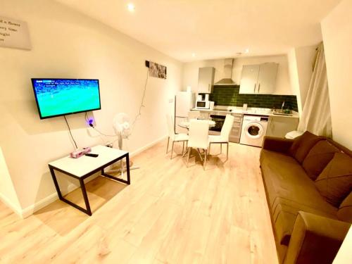 a living room with a couch and a table at One Bedroom Apartment in Ealing Broadway London in Ealing