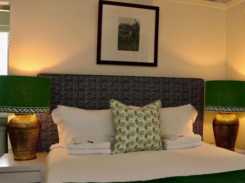 a bedroom with a bed with green and white pillows at Edward Lodge New Fam in Brisbane