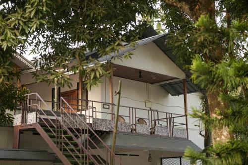 a building with a staircase in front of it at Marari Bobans villa in Mararikulam