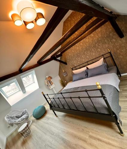 a bedroom with a large bed in a attic at HEIMATliebe Ferienhaus für 4 in Blankenhain